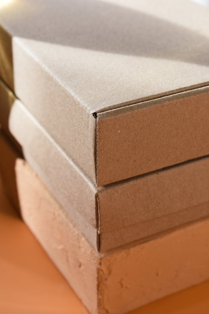 Close-up photo of stacked cardboard boxes, showcasing texture and material quality.